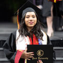 Student in cap and gown holding diploma